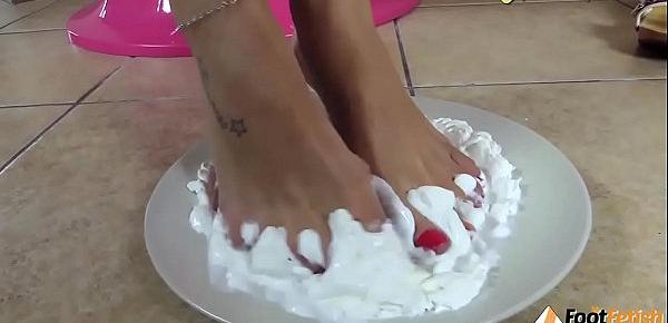  Barefoot brunette covers her feet in sweet cream